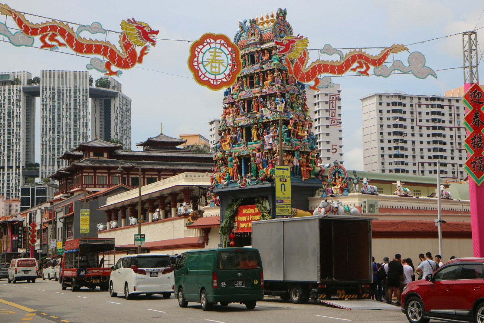 A busy city street with cars, trucks, and buildings